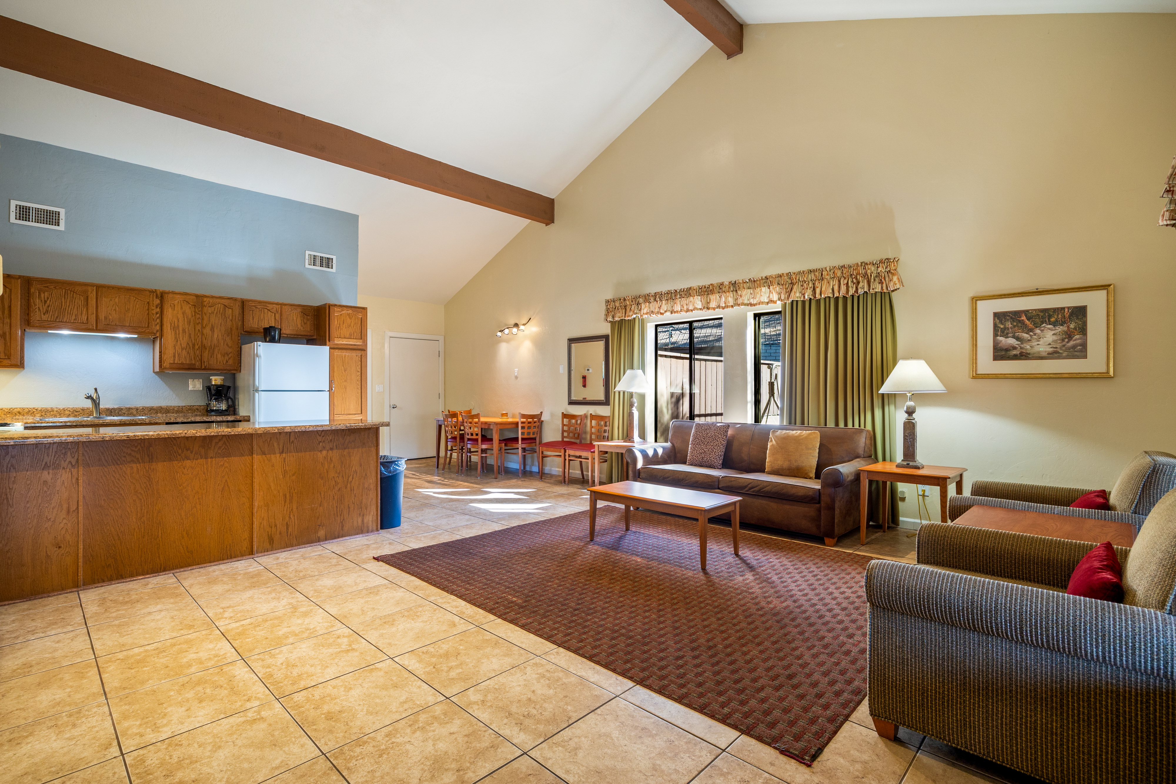 One bedroom deluxe with vaulted ceilings, exposed beams, and spacious living area